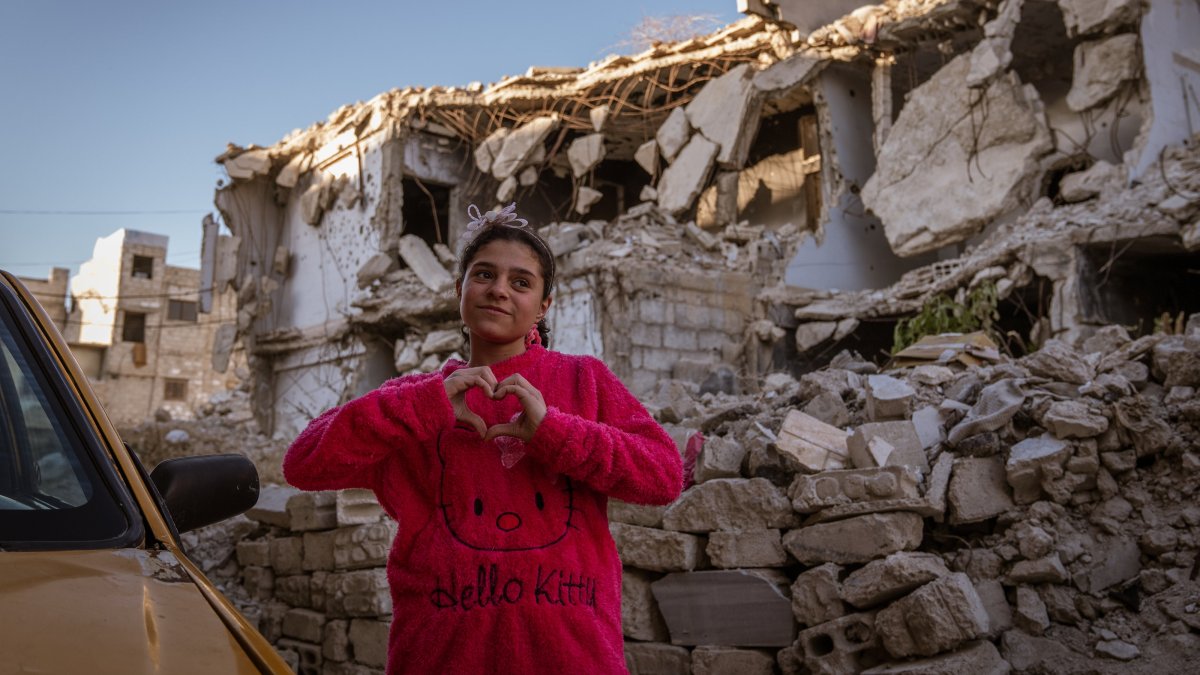A girl poses in a neighborhood devastated by the Syrian civil war, in Kabun, a suburb of Damascus, Syria, Dec. 25, 2024. (AA Photo)