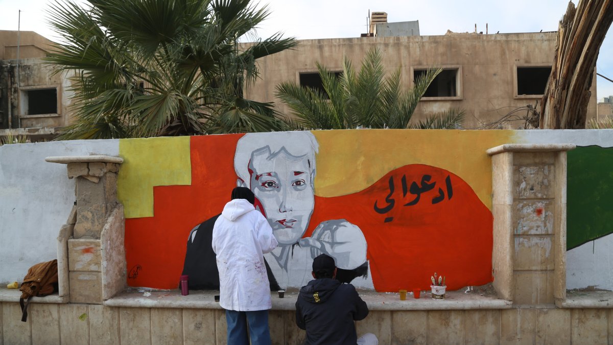 Young people voluntarily erase remnants of the Baath regime with graffiti art in Deir ez-Zor, Syria, Dec. 25, 2024. (AA Photo)