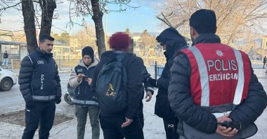 Police officers check the ID of a man during inspections of migrants, Erzincan, eastern Türkiye, Dec. 27, 2024. (İHA Photo)