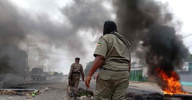 Mozambican security forces are seen next to a burning barricade amid demonstrations, Maputo, Mozambique, Dec. 24, 2024. (AFP Photo)