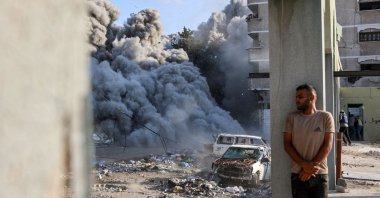 A man takes cover behind a column as an explosion propagates smoke and dust during an Israeli strike that targeted a school in the Zeitoun district on the outskirts of Gaza City, Palestine, Sept. 1, 2024. (AFP Photo)