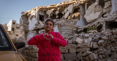 A girl poses in a neighborhood devastated by the Syrian civil war, in Kabun, a suburb of Damascus, Syria, Dec. 25, 2024. (AA Photo)