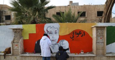 Young people voluntarily erase remnants of the Baath regime with graffiti art in Deir ez-Zor, Syria, Dec. 25, 2024. (AA Photo)