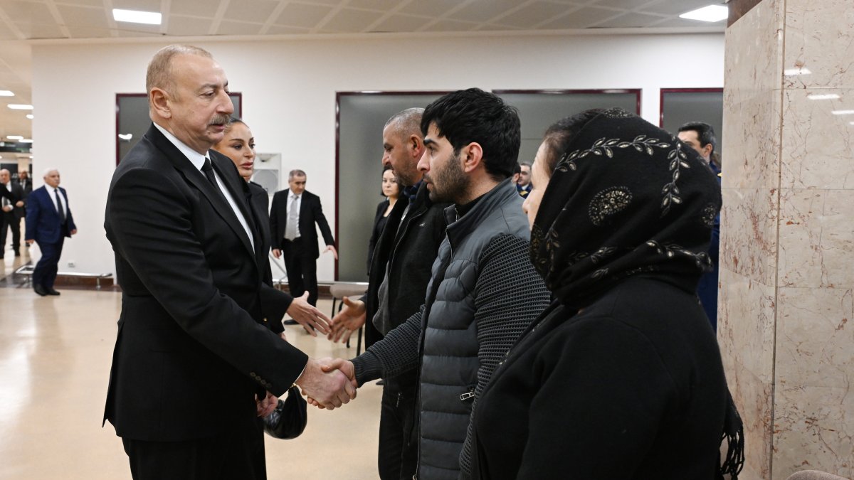 Azerbaijan President Ilham Aliyev (L) greets families of plane crash victims during a state program, Baku, Azerbaijan, Dec. 29, 2024. (AA Photo)