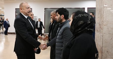 Azerbaijan President Ilham Aliyev (L) greets families of plane crash victims during a state program, Baku, Azerbaijan, Dec. 29, 2024. (AA Photo)