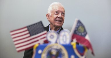 Former President Jimmy Carter stands behind his birthday cake during his 90th birthday celebration held at Georgia Southwestern University, in Americus, Georgia, U.S., Oct. 4, 2014. (AP Photo)
