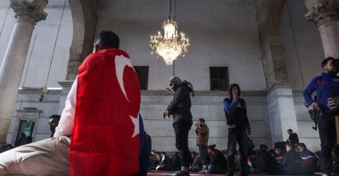 A person with a Turkish flag sits as people pray in the Umayyad Mosque after Syria&#039;s Bashar Assad was ousted, Damascus, Syria, Dec. 27, 2024. (Reuters Photo)
