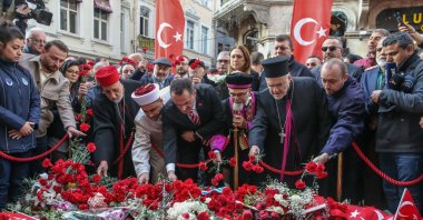 People leave flowers in memory of victims at the site of the Istiklal Street attack, Istanbul, Türkiye, Nov. 16, 2022. (AA Photo)
