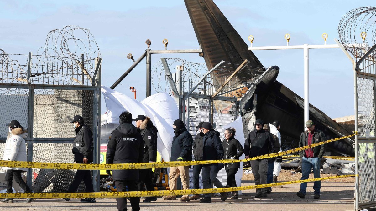 Investigators from South Korea and the U.S., including officials from the U.S. National Transportation Safety Board (NTSB) and aircraft manufacturer Boeing, inspect the scene where a Jeju Air Boeing 737-800 aircraft crashed and burst into flames at Muan International Airport in Muan, some 288 kilometers southwest of Seoul, South Korea, Dec. 31, 2024. (AFP Photo)