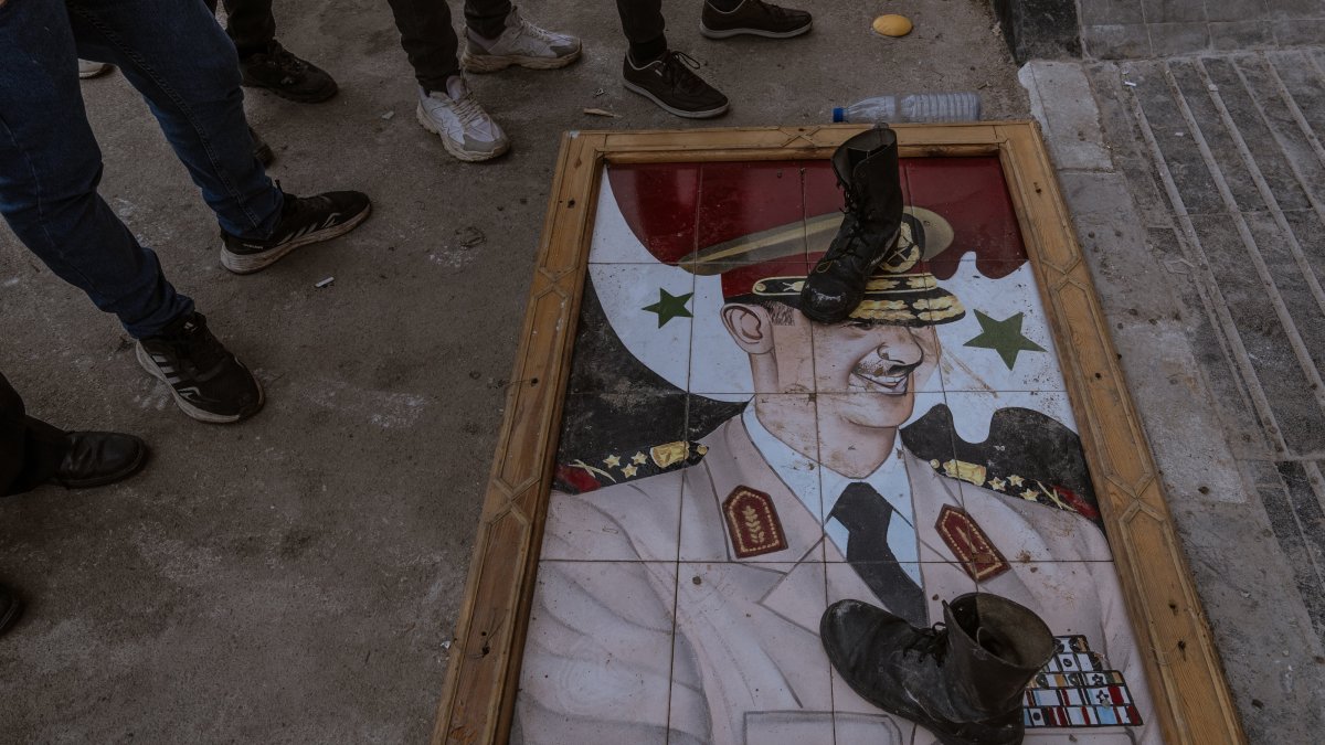 Syrian soldiers and police surrender arms to the transitional government after the Baath regime&#039;s fall, stepping on Bashar Assad&#039;s photo, Damascus, Syria, Dec. 22, 2024. (AA Photos)