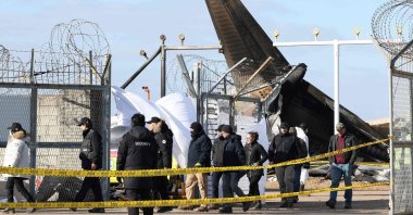 Investigators from South Korea and the U.S., including officials from the U.S. National Transportation Safety Board (NTSB) and aircraft manufacturer Boeing, inspect the scene where a Jeju Air Boeing 737-800 aircraft crashed and burst into flames at Muan International Airport in Muan, some 288 kilometers southwest of Seoul, South Korea, Dec. 31, 2024. (AFP Photo)