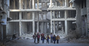 Children walk down a street in the Yarmouk refugee camp on the outskirts of Damascus, Syria, Dec. 19, 2024. (EPA Photo)