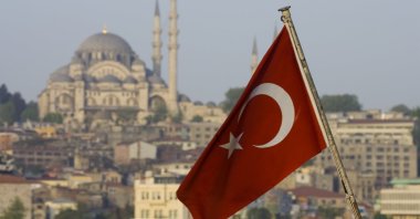 The Turkish flag is backdropped by the city&#039;s famous Süleymaniye Mosque, Istanbul, Türkiye. (Getty Images Photo)