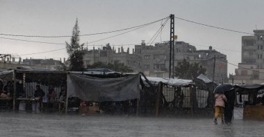 Internally displaced Palestinians check their tents, which were flooded during heavy rains in Khan Yunis, Gaza Strip, Palestine, Dec. 31, 2024. (EPA Photo) 