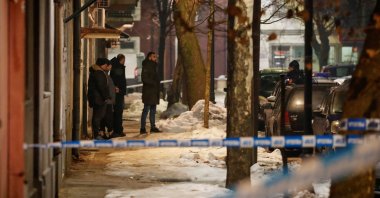 Police and security personnel stand on a street in front of a firetruck near the scene where a gunman opened fire at a restaurant and killed several people, Cetinje, Montenegro, Jan. 1, 2025. (Reuters Photo)