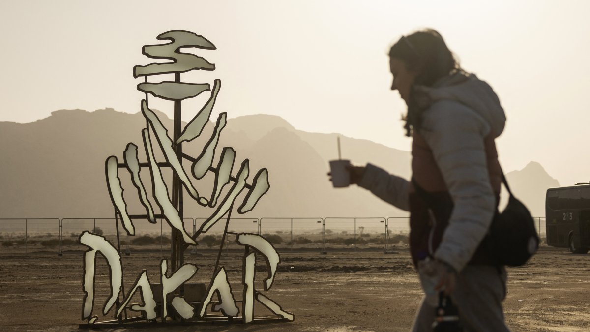 A woman walks past a Dakar Rally logo installation ahead of the Dakar Rally, Bisha, Saudi Arabia, Jan. 2, 2025. (Reuters Photo)