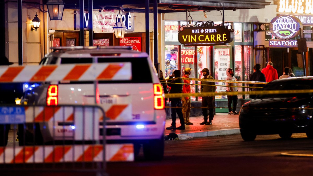 Law enforcement vehicles and people stand near the area near the scene where a vehicle drove into a crowd during New Year&#039;s celebrations, in New Orleans, Louisiana, U.S., January 1, 2025. REUTERS/Eduardo Munoz