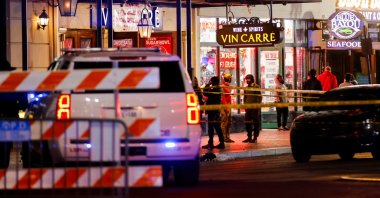 Law enforcement vehicles and people stand near the area near the scene where a vehicle drove into a crowd during New Year&#039;s celebrations, in New Orleans, Louisiana, U.S., January 1, 2025. REUTERS/Eduardo Munoz