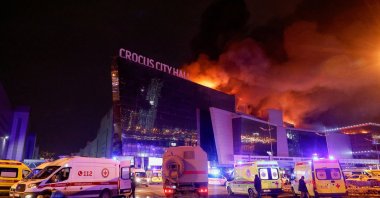 Vehicles of Russian emergency services are parked near the burning Crocus City Hall concert venue following the attack, Moscow, Russia, March 22, 2024. (Reuters Photo)