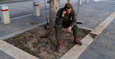 An Israeli soldier uses his phone near the border with Gaza, in Israel, Dec. 16, 2024. (Reuters Photo)