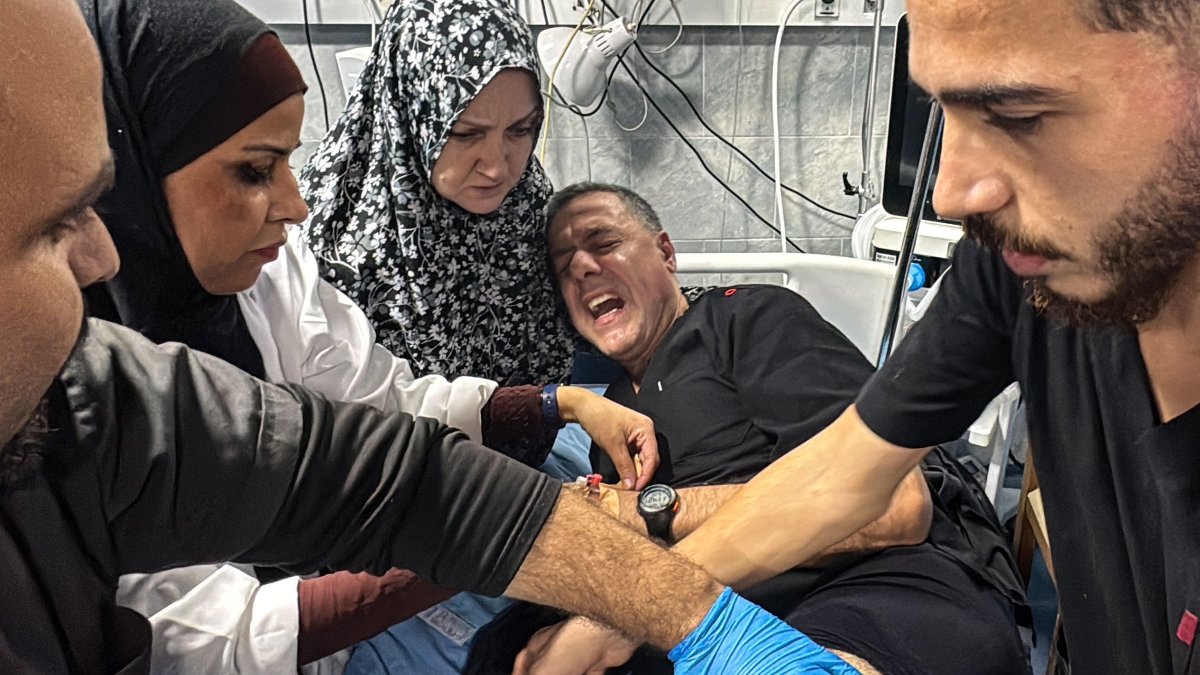 Hossam Abu Safieh, director of the Kamal Adwan Hospital, is treated by colleagues for his injuries following an Israeli strike that according to the civil defense in Gaza hit the medical compound, Beit Lahia, Gaza Strip, Nov. 23, 2024. (AFP Photo)