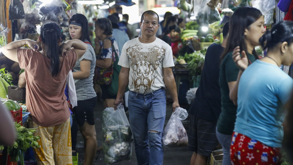 A customer carries bags of food items bought at a market in Quezon City, Metro Manila, Philippines, Dec. 5, 2024. (EPA Photo)