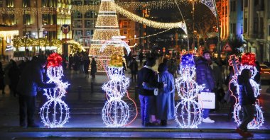 People stroll at the illuminated Şişhane Square on New Year's Eve, central Istanbul, Türkiye, Dec. 31, 2024. (Reuters Photo)
