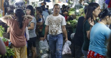 A customer carries bags of food items bought at a market in Quezon City, Metro Manila, Philippines, Dec. 5, 2024. (EPA Photo)