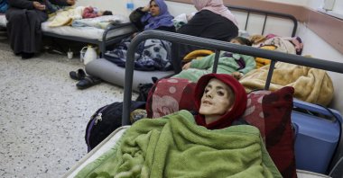 Ten-year-old Palestinian boy, Yazan al-Kafarneh, displaced from Beit Hanun, lies on a hospital bed at Al-Awda clinic in Rafah, in the southern Gaza Strip, Feb. 29, 2024. (AFP File Photo)
