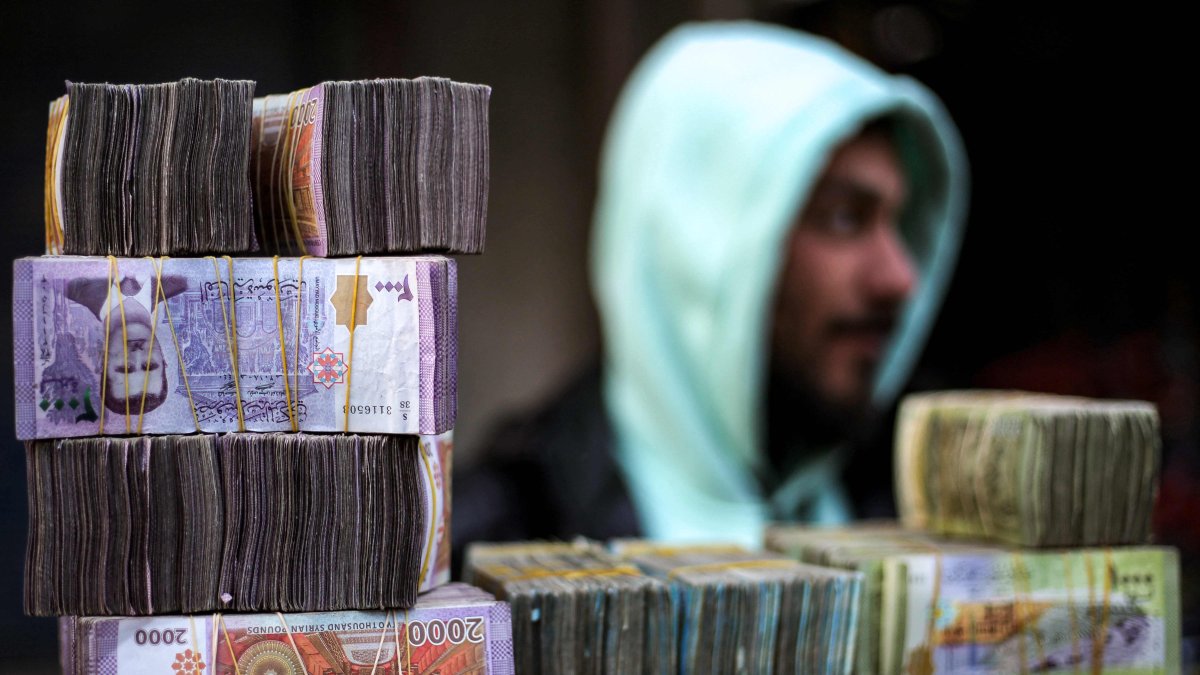 Stacks of Syrian pound banknotes are piled on top of each other at a currency trader&#039;s stall at a market, Manbij, Syria, Jan. 4, 2025. (AFP Photo)