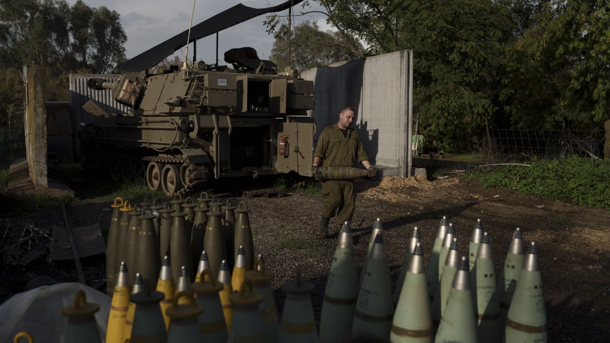 An Israeli soldier carries a howitzer shell near the border with Lebanon, in northern Israel, Jan. 11, 2024. (AP Photo)