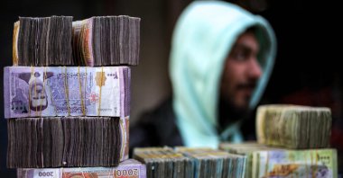 Stacks of Syrian pound banknotes are piled on top of each other at a currency trader&#039;s stall at a market, Manbij, Syria, Jan. 4, 2025. (AFP Photo)