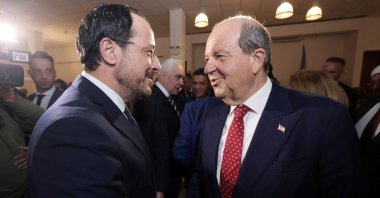 Greek Cypriot administration leader Nikos Christodoulides (L) and Turkish Cypriot President Ersin Tatar (R) shake hands in the U.N. buffer zone in Lefkoşa (Nicosia), Cyprus, Dec. 10, 2024. (Reuters Photo)