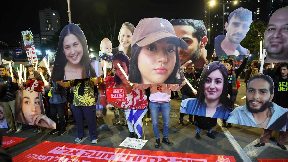 Protesters hold cutout portraits of hostages held captive in Gaza by Palestinian resistance groups since the Oct. 7 incursion, during a demonstration calling for action to secure their release, in Tel Aviv, Israel, Jan. 4, 2025. (AFP Photo)