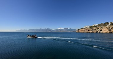 A boat navigates local waters on a sunny day in Kaleiçi amid mild air and sea temperatures, Antalya, Türkiye, Jan. 6, 2024. (AA Photo)