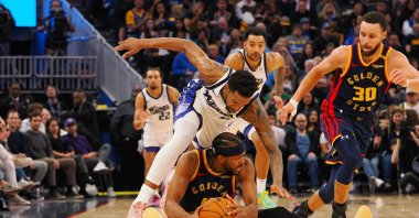 Sacramento Kings guard Malik Monk dives off Golden State Warriors guard Moses Moody as he looks to pass the ball to guard Stephen Curry (R) from the floor during the third quarter at Chase Center, San Francisco, California, U.S., Jan. 5, 2025. (Reuters Photo)