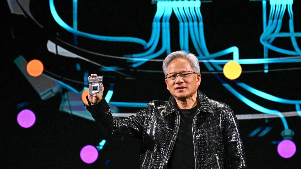 Nvidia CEO Jensen Huang holds a Nvidia&#039;s Drive Thor processor as he delivers a keynote address at the Consumer Electronics Show (CES) in Las Vegas, Nevada, U.S., Jan. 6, 2025. (AFP Photo)