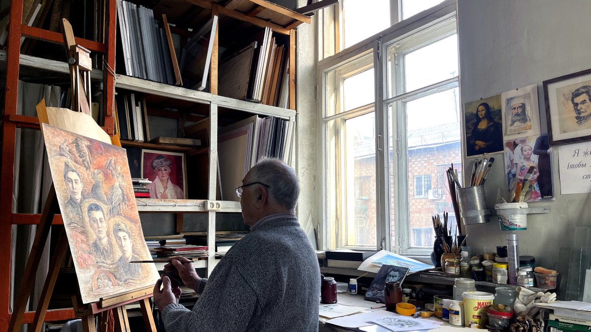 Sabidjan Babadjanov, 84, paints in his studio, creating illustrations inspired by the works of Kyrgyz author Chinghiz Aitmatov, Bishkek, Kyrgyzstan, Dec. 12, 2024. (AA Photo)