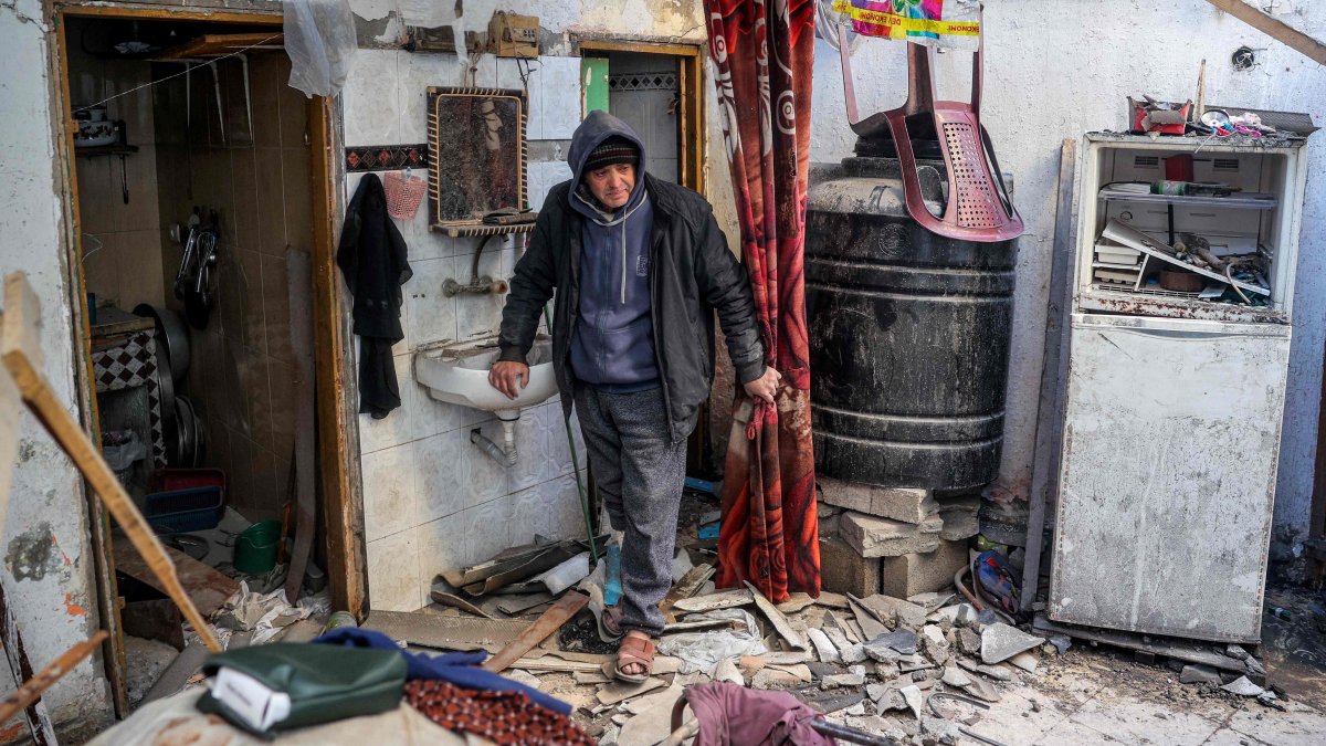 A man walks through debris in an apartment building hit by Israeli bombardment in the Bureij refugee camp, in the central Gaza Strip, Palestine, Jan. 7, 2025. (AFP Photo)