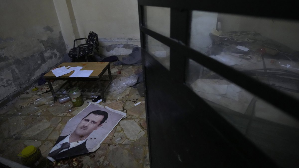 A portrait of ousted Bashar Assad lies on the ground at Branch 215, a detention facility run by former military intelligence, in Damascus, Syria, on Dec. 17, 2024. (AP Photo)