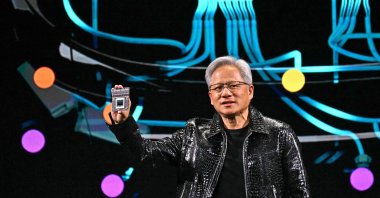 Nvidia CEO Jensen Huang holds a Nvidia&#039;s Drive Thor processor as he delivers a keynote address at the Consumer Electronics Show (CES) in Las Vegas, Nevada, U.S., Jan. 6, 2025. (AFP Photo)