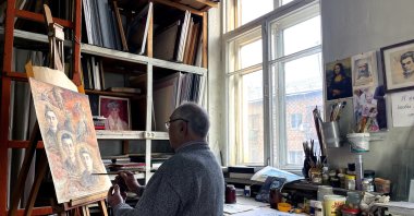 Sabidjan Babadjanov, 84, paints in his studio, creating illustrations inspired by the works of Kyrgyz author Chinghiz Aitmatov, Bishkek, Kyrgyzstan, Dec. 12, 2024. (AA Photo)