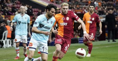 Galatasaray's Barış Alper Yılmaz (R) and Başakşehir's Leo Dubois vie for the ball during the Süper Lig match at RAMS Park, Istanbul, Türkiye, Feb. 10, 2024. (IHA Photo)