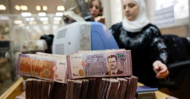Bundles of Syrian currency notes are stacked up as an employee counts money at the Syrian central bank after the ousting of Syria&#039;s Bashar Assad, Damascus, Syria, Dec. 16, 2024. (Reuters Photo)