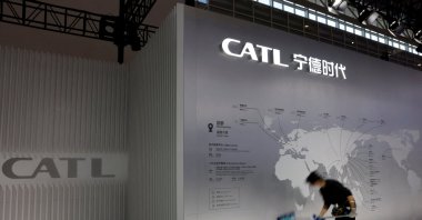 A staff member cleans a display showing the locations of battery maker CATL&#039;s production bases, at the CATL booth during the first China International Supply Chain Expo (CISCE), Beijing, China, Nov. 28, 2023. (Reuters Photo)