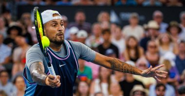 Australia's Nick Kyrgios hits a return during the men's doubles match against Michael Venus of New Zealand and Nikola Mektic of Croatia at the Brisbane International, Brisbane, Australia, Jan. 1, 2025. (AFP Photo)