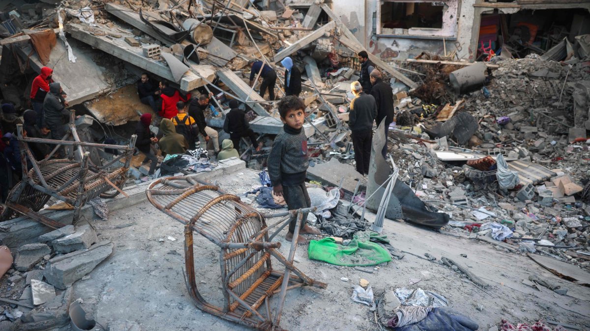 A Palestinian child stands among debris as people search the rubble of a building destroyed in an Israeli strike on the Bureij refugee camp, central Gaza Strip, Palestine, Jan. 8, 2025. (AFP Photo)