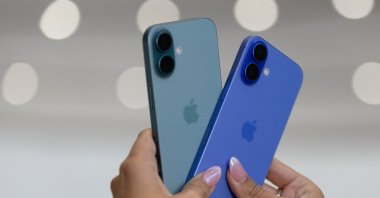 An attendee holds two iPhones 16 as Apple holds an event at the Steve Jobs Theater on its campus in Cupertino, California, U.S., Sept. 9, 2024. (Reuters Photo)