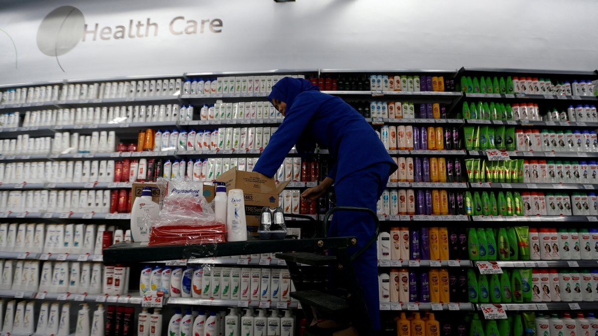 An employee of PT Unilever Indonesia arranges a health care rack at a Foodmart Fresh supermarket in Jakarta, Indonesia, Oct. 31, 2016. (Reuters Photo)