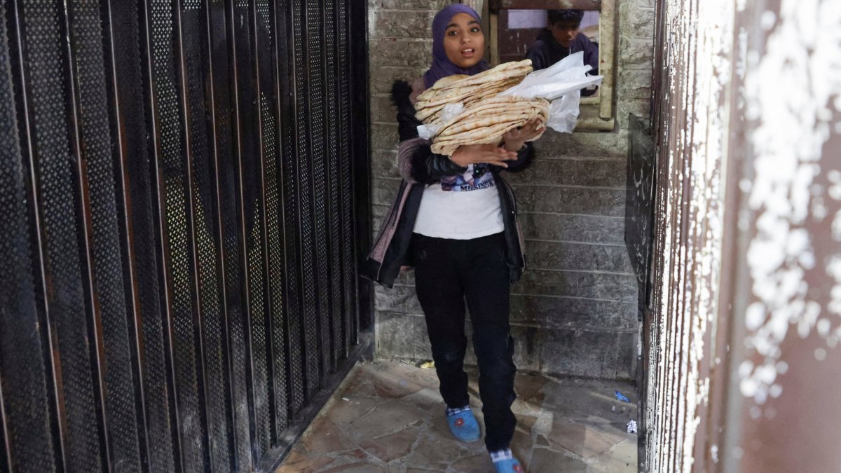 A girl walks out of a bakery with bread in Damascus, Syria, Jan. 6, 2025. (Reuters Photo)